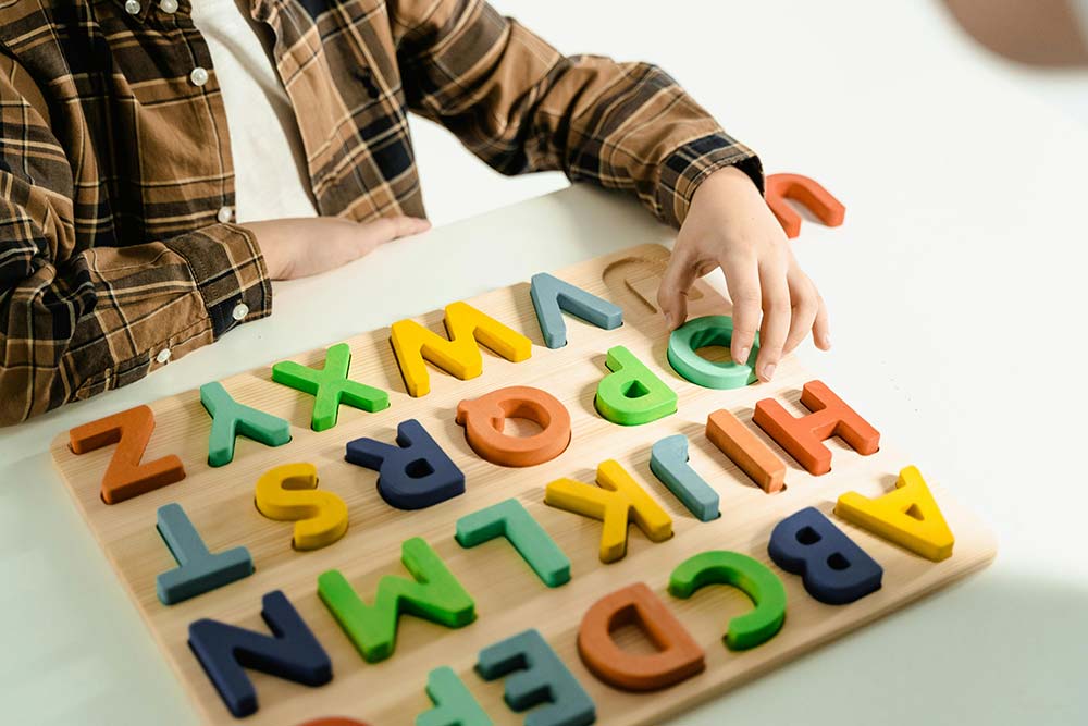 Child playing with an alphabet puzzle