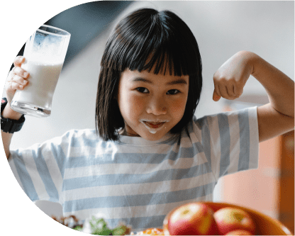A cheerful girl flexes her muscles with arms raised high.