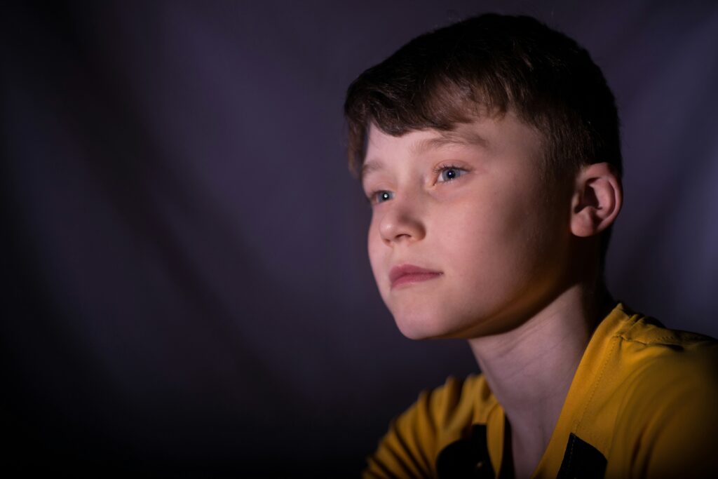 Young boy staring off into the distance.