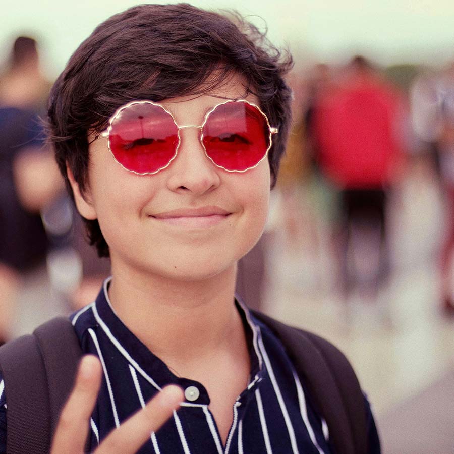 smiling teenager wearing sunglasses