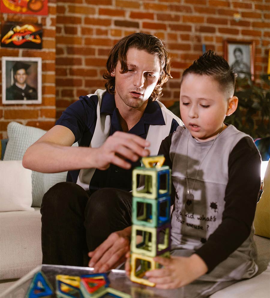 therapist and little boy playing with blocks during a behavior assessment